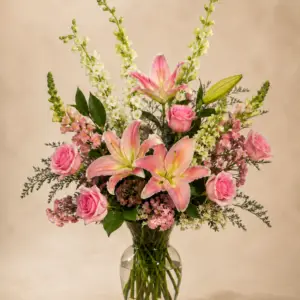 Shades of Pink arrangement with pink roses, pink lilies and seasonal flowers in a clear glass vase by a Santa Monica florist