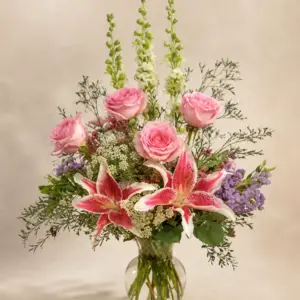 Timeless Grace floral arrangement with pink roses, pink stargazer lilies, white snapdragon, lavender accents, and airy greenery in a clear glass vase by a Santa Monica flower studio.